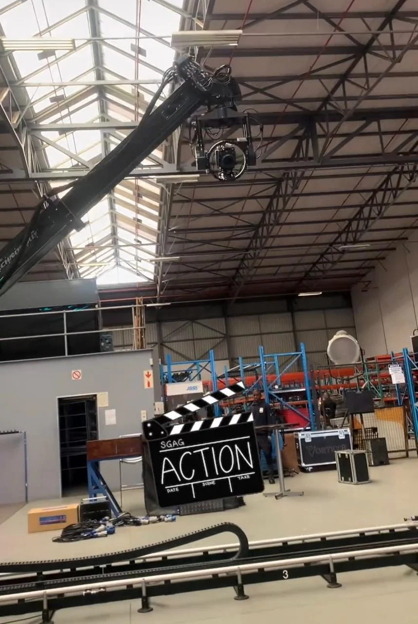 A film studio floor with lighting rig and clapperboard